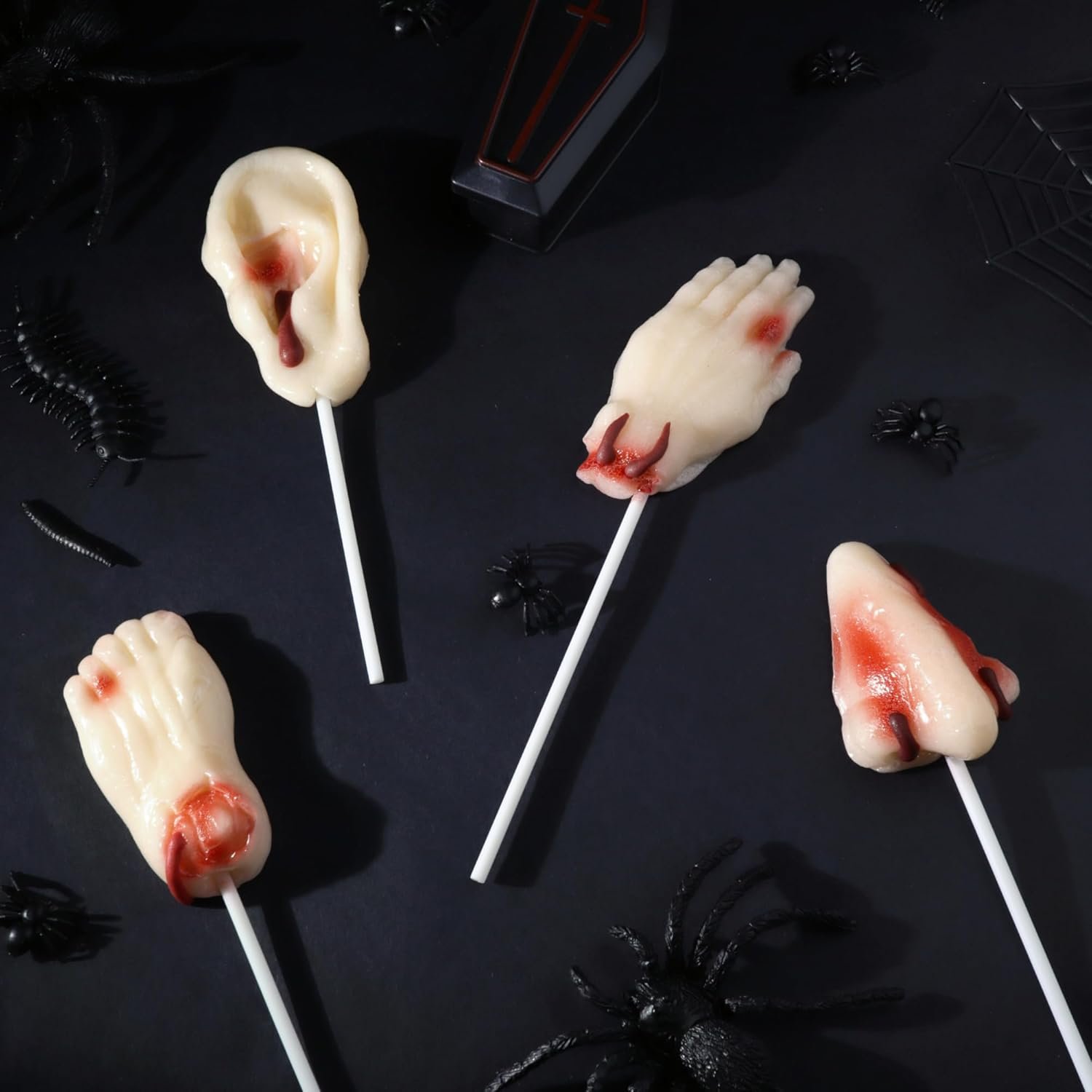 Halloween lollipops shaped like body parts (nose, foot, hand).
