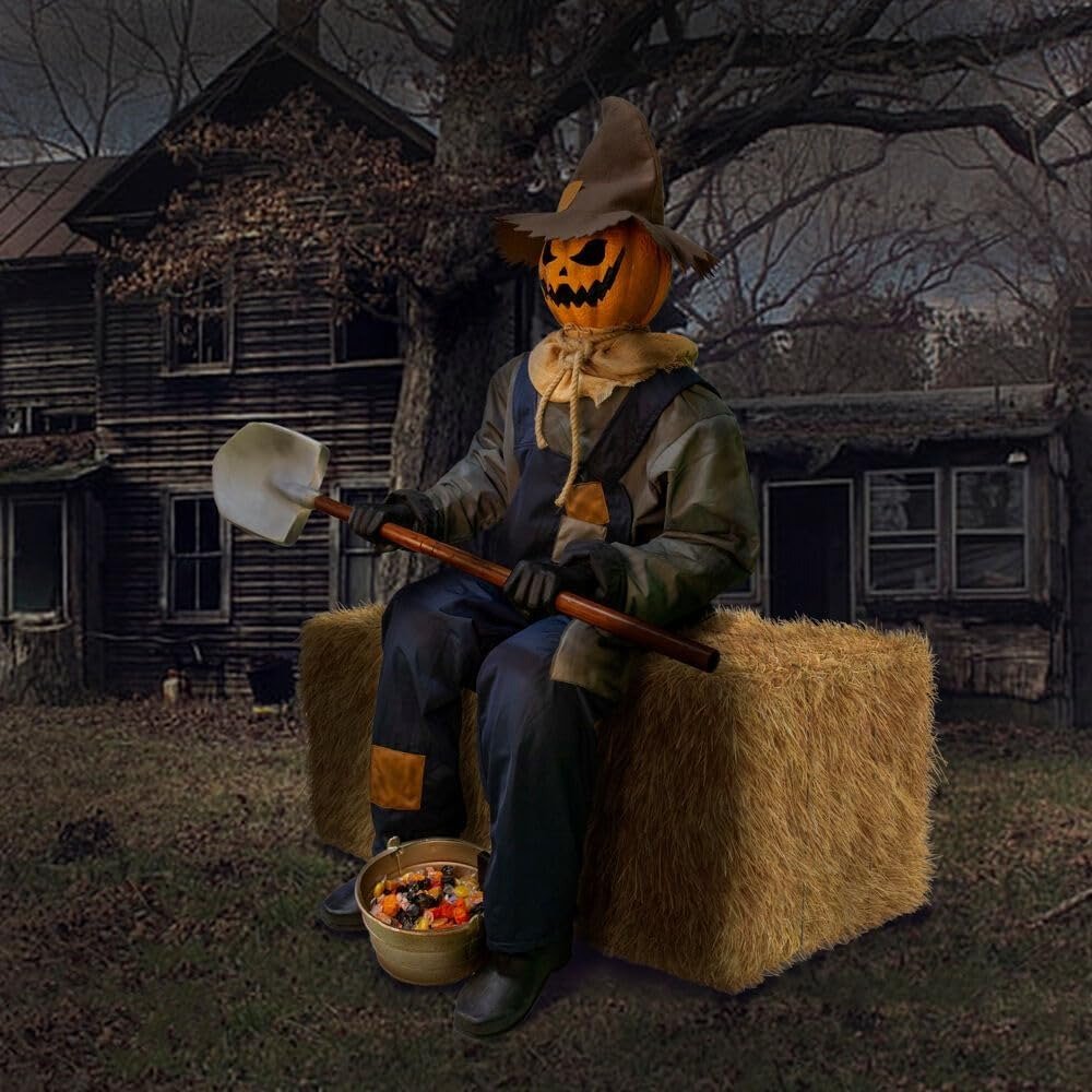 Motion-activated scarecrow sitting with a shovel and candy bowl, ready to jump-scare approaching guests.